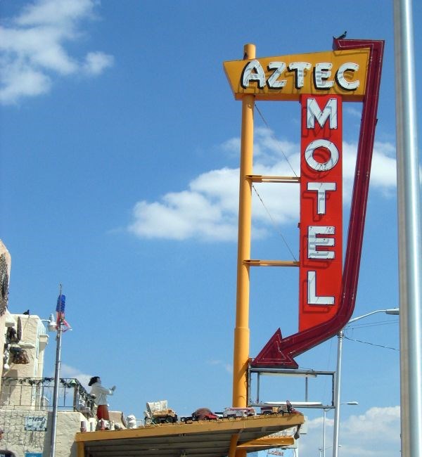 The Aztec Motel neon marquee against a blue sky, photographed in 2005