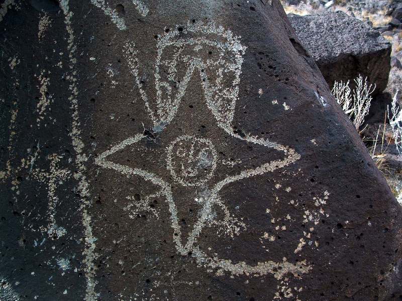 A star being figure pecked into dark basalt at Rinconada Canyon