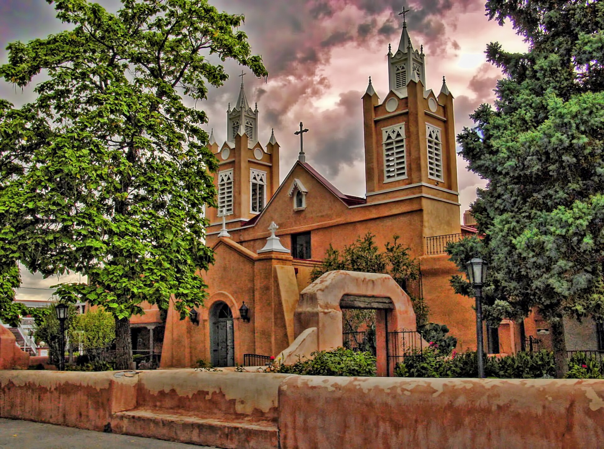 The twin bell towers and adobe facade of San Felipe de Neri Church