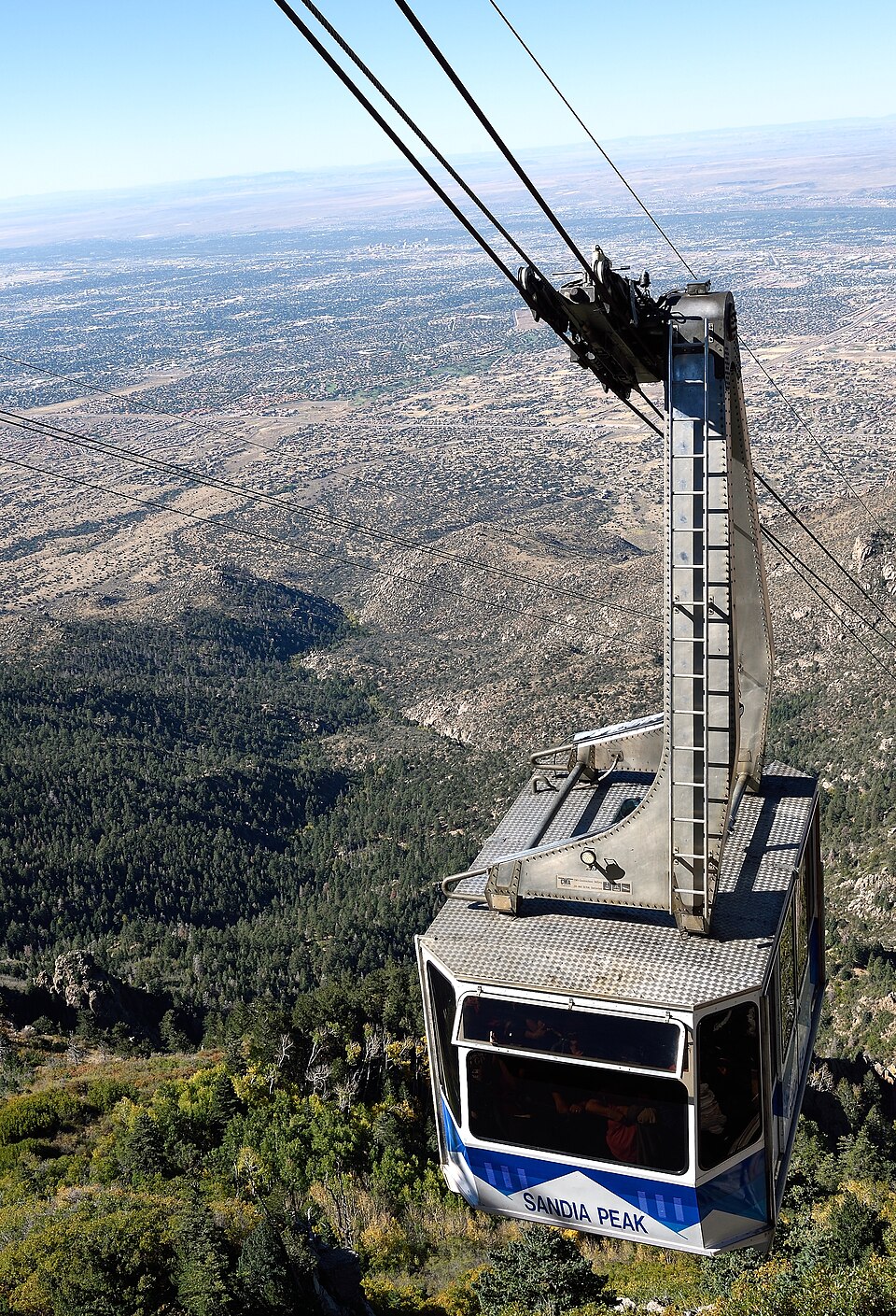 A Sandia Peak Tramway car climbing the granite face above Albuquerque