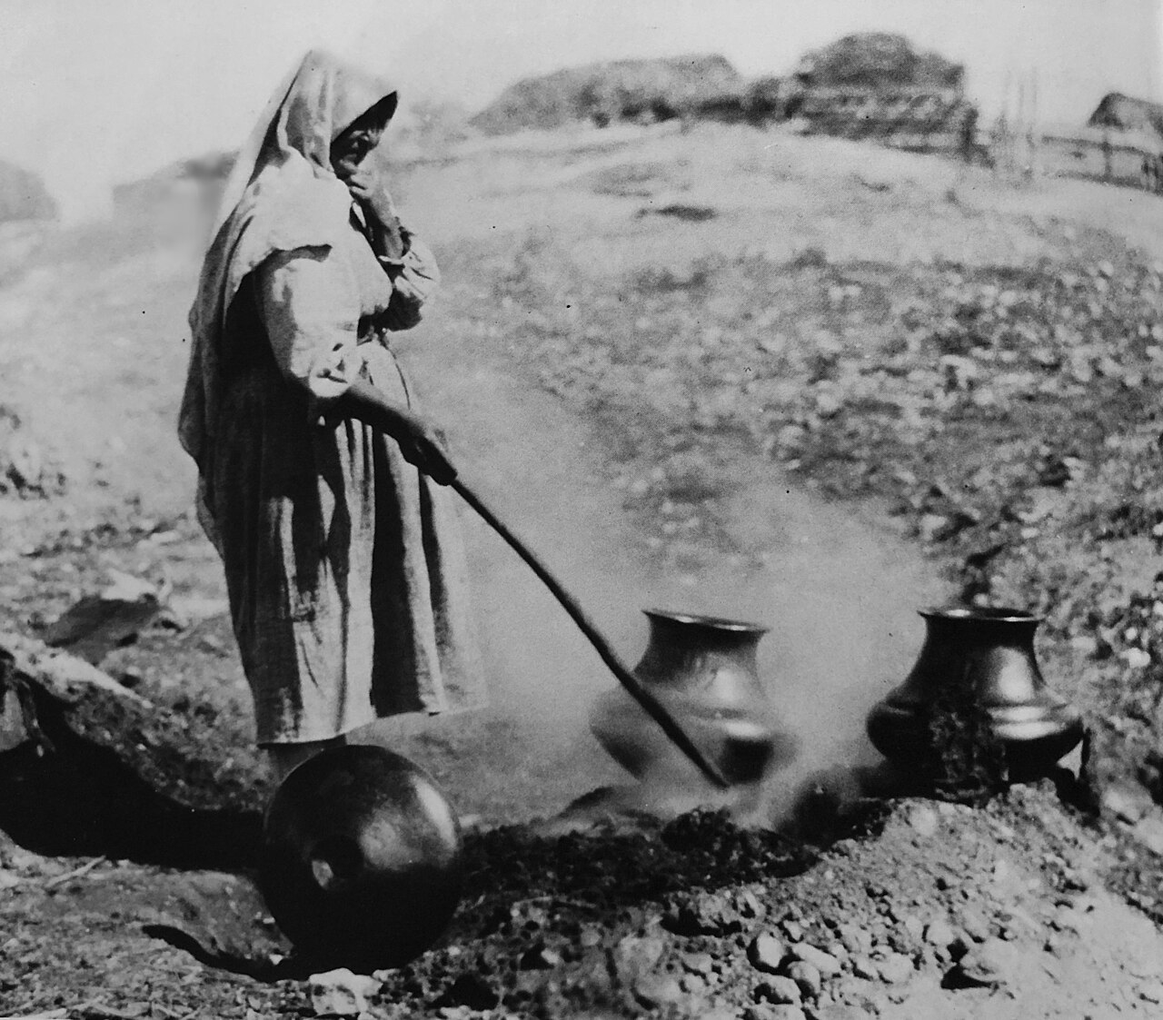 Sara Fina Tafoya firing traditional blackware pottery at Santa Clara Pueblo