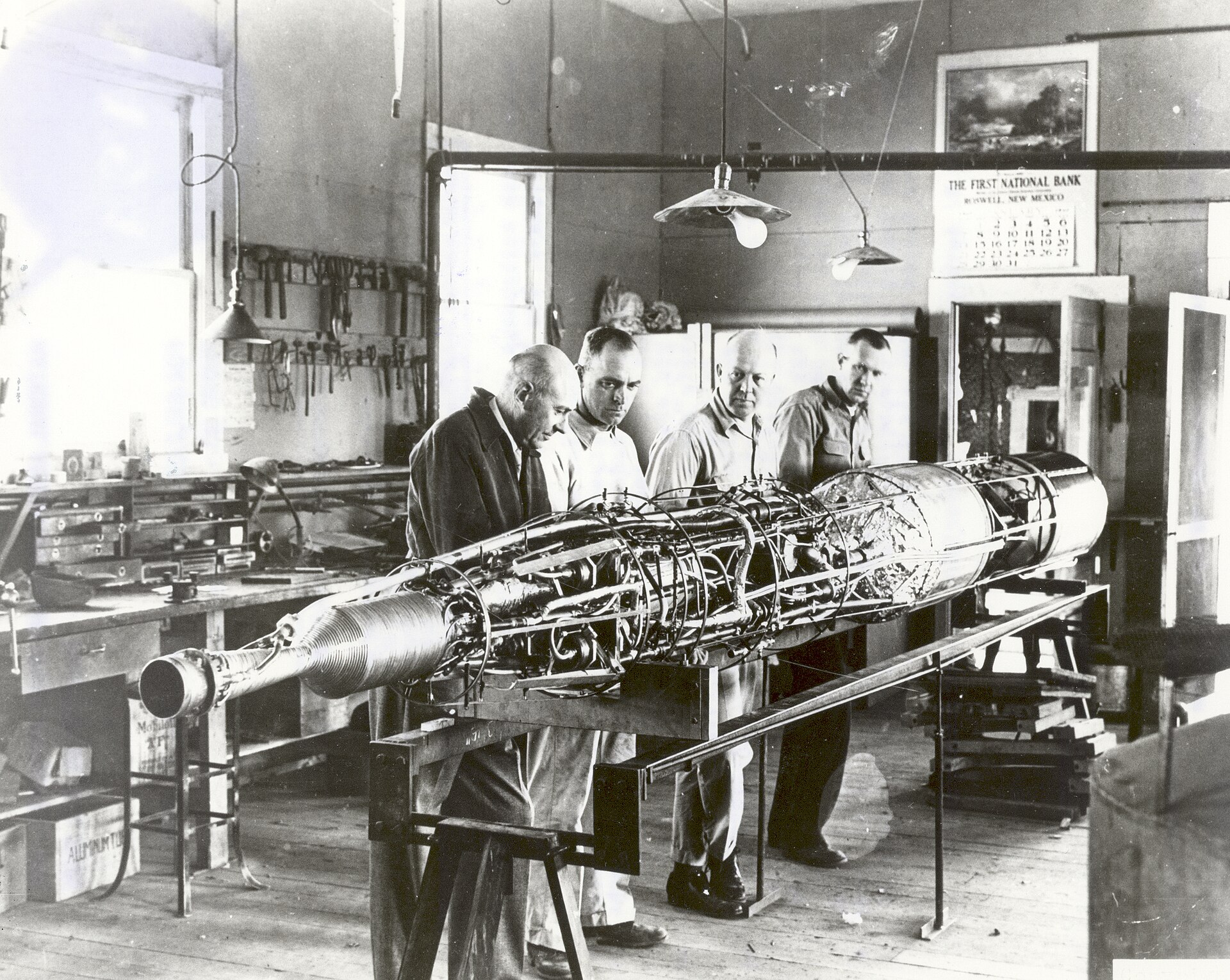 Robert H. Goddard and crew working on a rocket with turbopumps